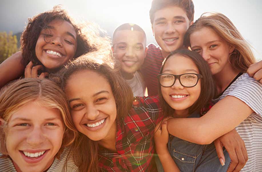 Happy teens laughing and hugging