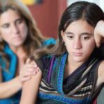 A mother tries to talk to her withdrawn teen daughter.