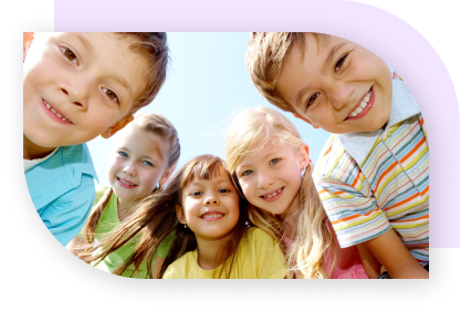 Five kids in a semi-circle looking down at the camera and smiling.
