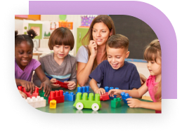 A therapist sitting with a group of children in play therapy.