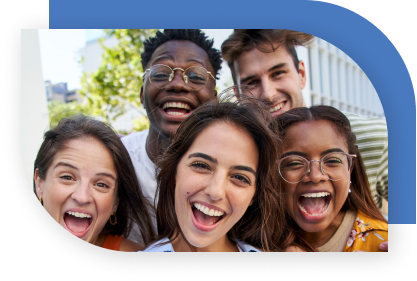 Young adults smiling and laughing as they look at the camera.